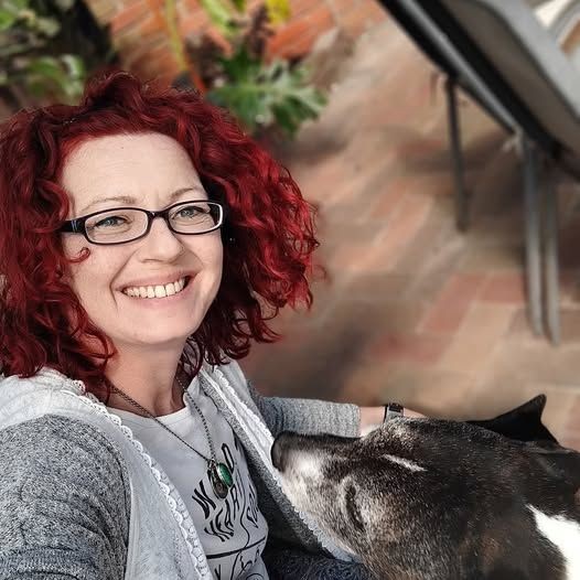 Smiling Lady, glasses red curly hair