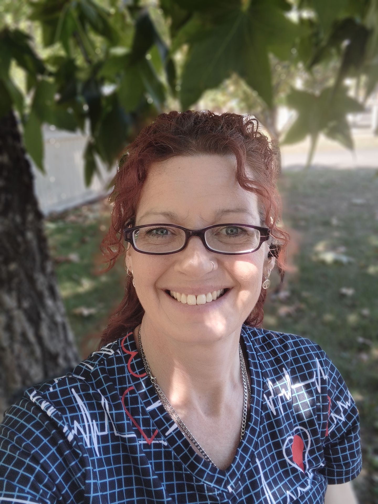Lainey - Elaine Bowler Reiki - smiling lady with glasses and red curly hair
