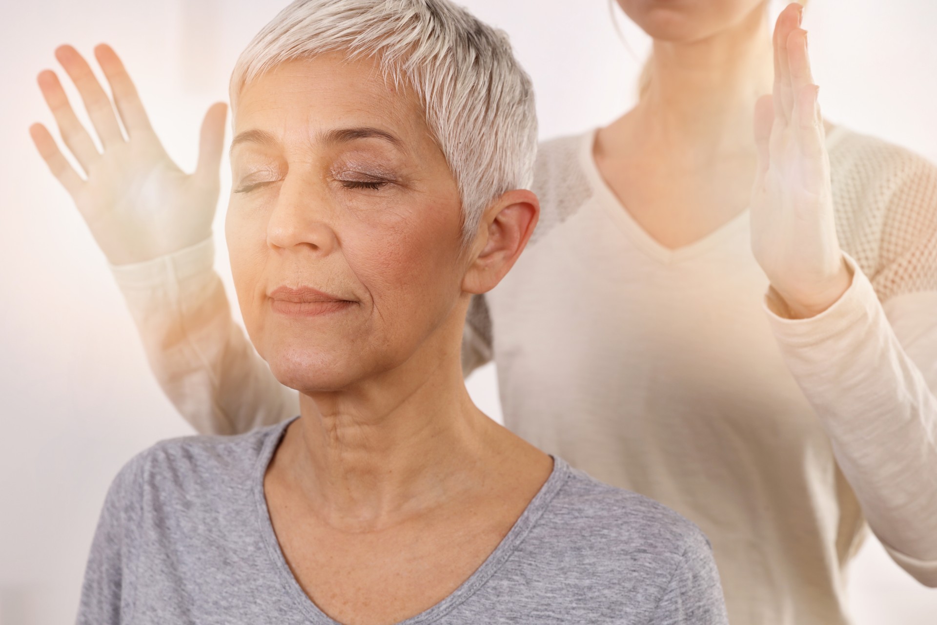 Woman having reiki healing treatment , Complementary medicine concept, holistic care